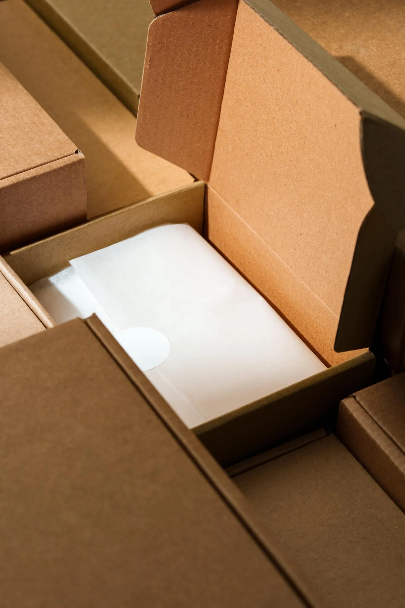 Eco-friendly cardboard mailer box with tissue-wrapped item