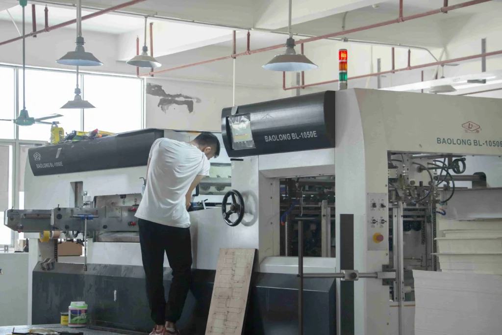 Technician adjusting packaging machine for optimal function