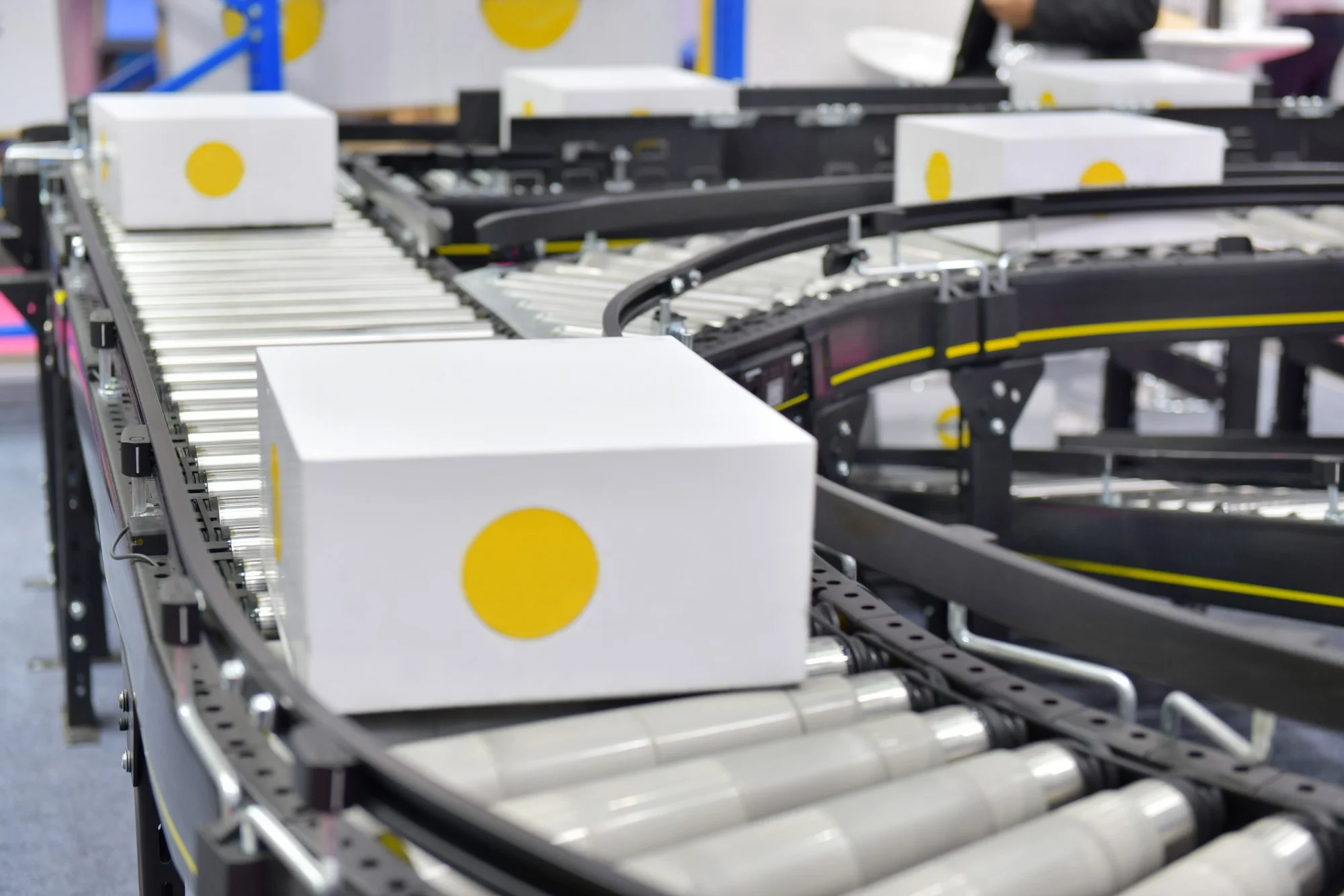 White boxes on automated packaging conveyor system